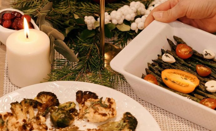 Weihnachtlich geschmückter Tisch mit Festessen.